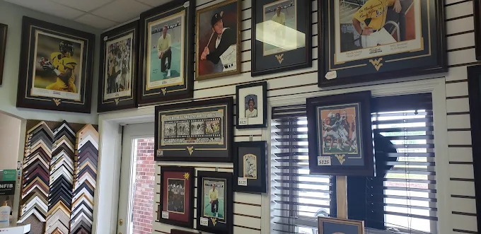 Wall of framed sports prints at All-Pro studio